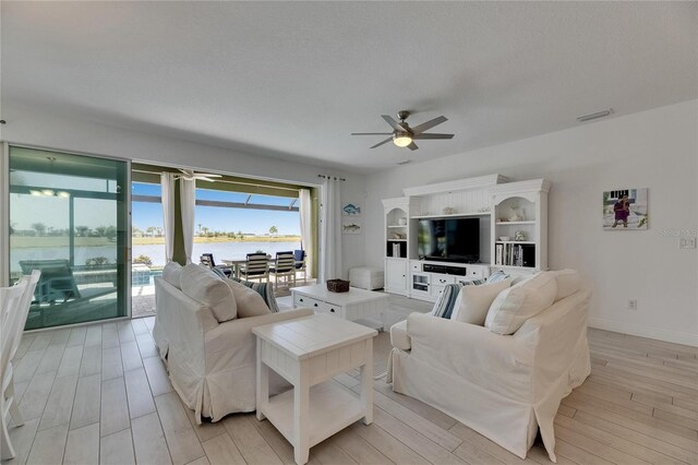 5814 Silver Sun Dr, Apollo Beach, FL 33572 - living area featuring ceiling fan, light wood-type flooring, and baseboards