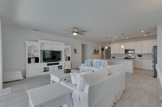 5814 Silver Sun Dr, Apollo Beach, FL 33572 - living room with ceiling fan and recessed lighting