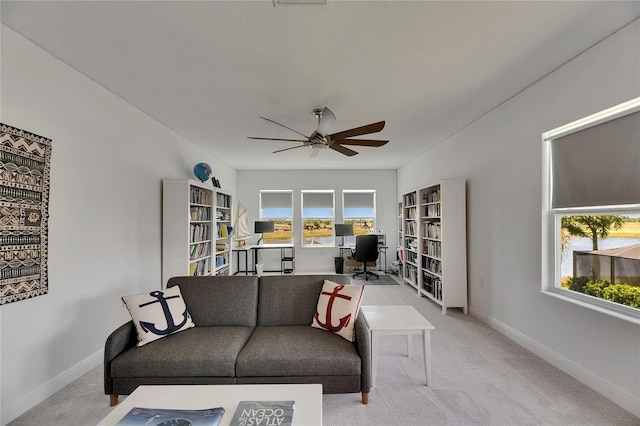 5814 Silver Sun Dr, Apollo Beach, FL 33572 - living area featuring ceiling fan, a desk, carpet floors, and baseboards