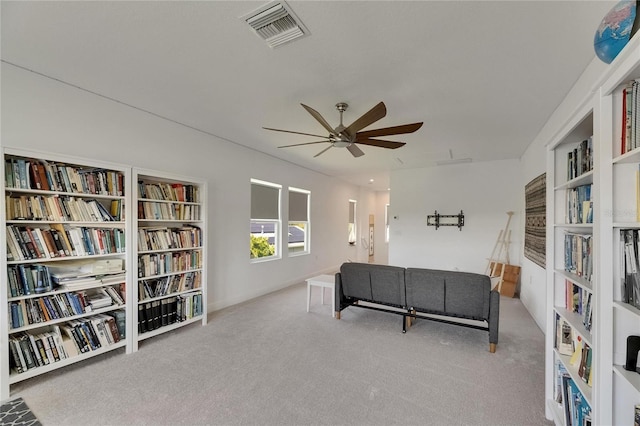 5814 Silver Sun Dr, Apollo Beach, FL 33572 - living area with ceiling fan, carpet floors, and wall of books