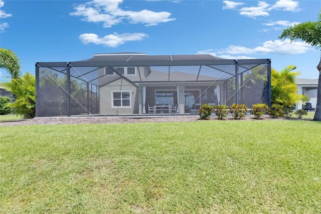5814 Silver Sun Dr, Apollo Beach, FL 33572 - rear view of property with a yard, glass enclosure, and stucco siding