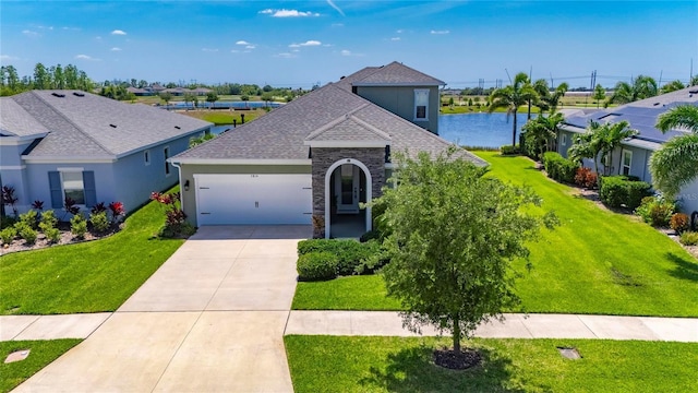 5814 Silver Sun Dr, Apollo Beach, FL 33572 - view of front of house with an attached garage, stone siding, concrete driveway, a front lawn, and a shingled roof