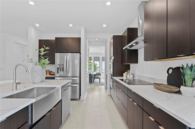 kitchen with light stone countertops, dark brown cabinets, modern cabinets, and appliances with stainless steel finishes