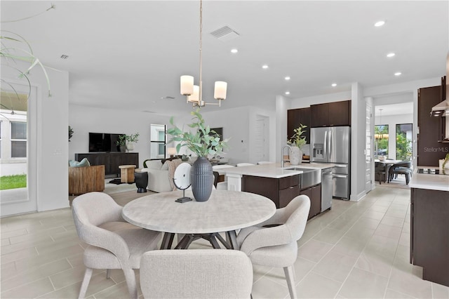 dining space featuring a chandelier, light tile patterned flooring, visible vents, and recessed lighting