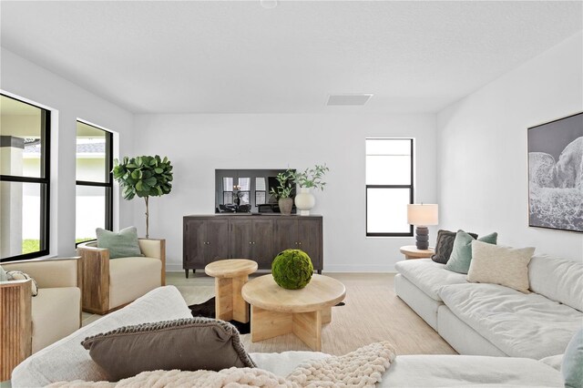 living room with baseboards and visible vents
