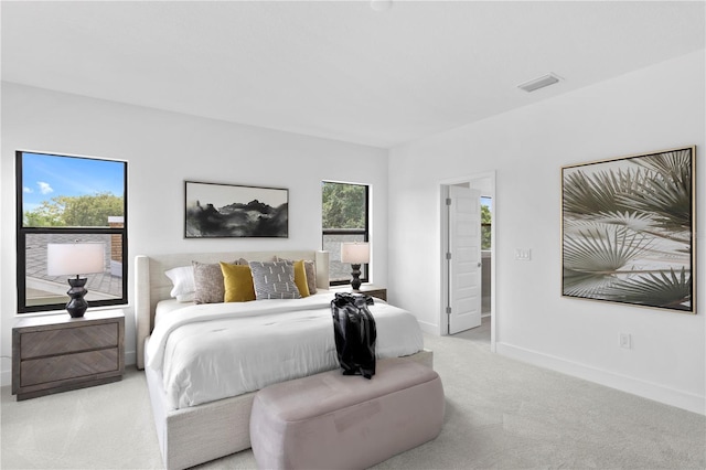 carpeted bedroom featuring visible vents and baseboards