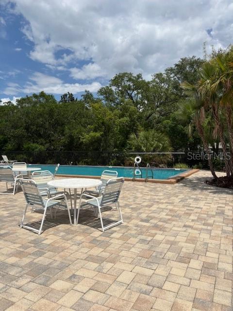 4127 Dolphin Dr Unit 4127, Tampa, FL 33617 - pool featuring a patio and fence