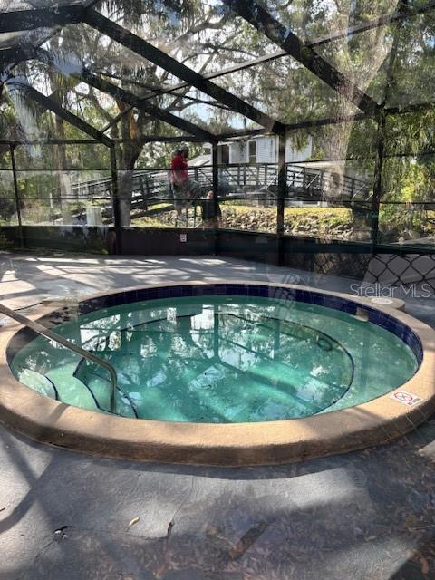 4127 Dolphin Dr Unit 4127, Tampa, FL 33617 - view of pool with glass enclosure and a patio area