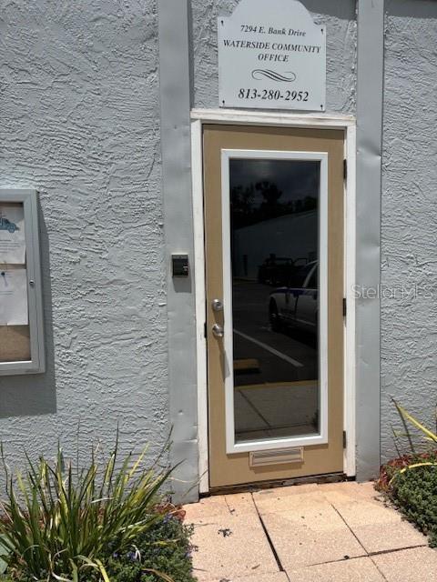 4127 Dolphin Dr Unit 4127, Tampa, FL 33617 - view of exterior entry with stucco siding