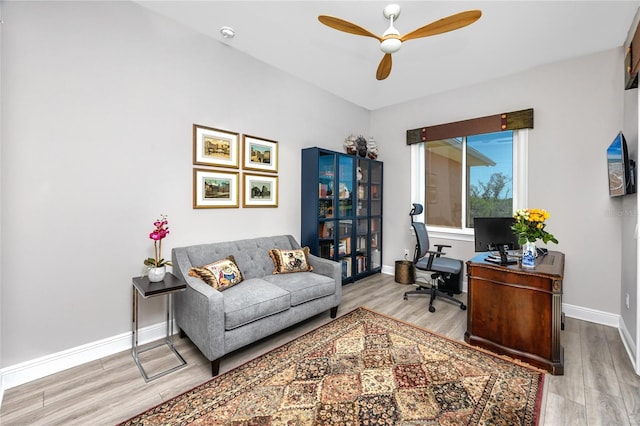 office space featuring wood finished floors, ceiling fan, and baseboards