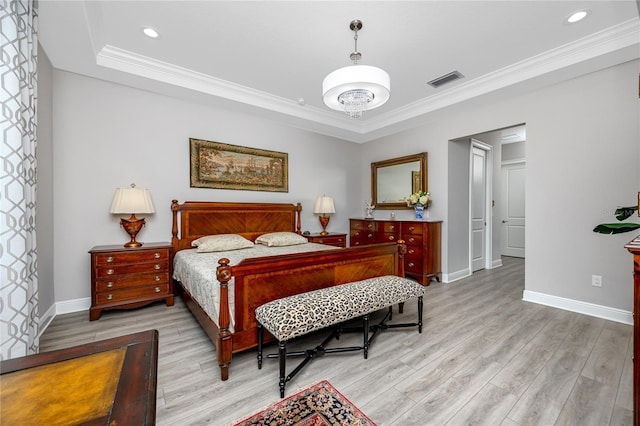 bedroom with light wood-style flooring, ornamental molding, baseboards, a tray ceiling, and recessed lighting