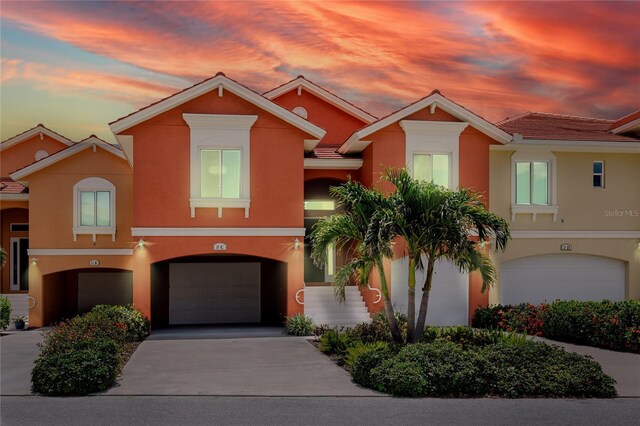 11 Franklin Ct S Unit C, Saint Petersburg, FL 33711 - multi unit property with stucco siding, an attached garage, concrete driveway, and a tile roof