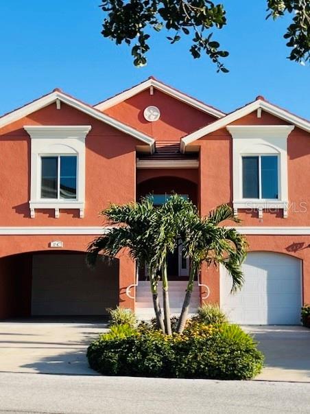 11 Franklin Ct S Unit C, Saint Petersburg, FL 33711 - view of front of house with a garage, stucco siding, and concrete driveway