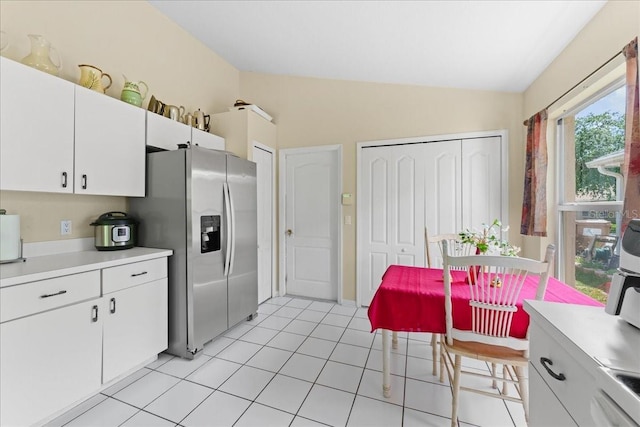7235 Sharpsburg Blvd, New Port Richey, FL 34653 - kitchen featuring light countertops, stainless steel refrigerator with ice dispenser, white cabinets, and lofted ceiling