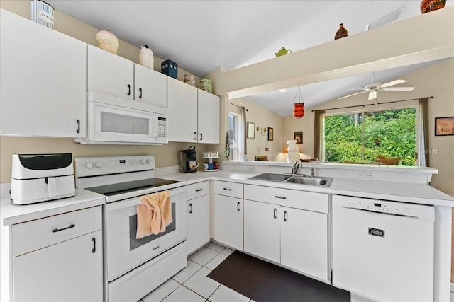 7235 Sharpsburg Blvd, New Port Richey, FL 34653 - kitchen with a sink, white appliances, light countertops, a peninsula, and lofted ceiling