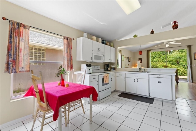 7235 Sharpsburg Blvd, New Port Richey, FL 34653 - kitchen featuring light countertops, a peninsula, vaulted ceiling, and white appliances