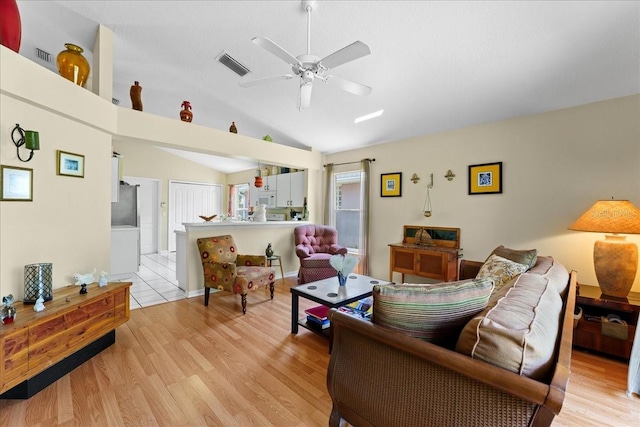 7235 Sharpsburg Blvd, New Port Richey, FL 34653 - living room featuring a ceiling fan, visible vents, lofted ceiling, and light wood-style floors