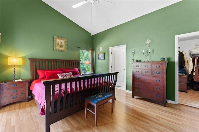 7235 Sharpsburg Blvd, New Port Richey, FL 34653 - bedroom with a walk in closet, wood finished floors, high vaulted ceiling, baseboards, and a closet