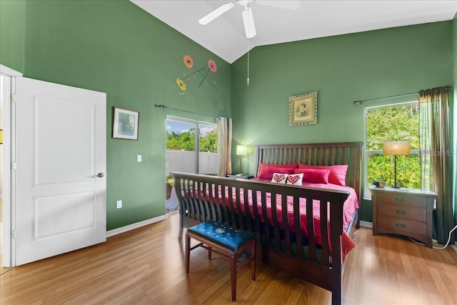 7235 Sharpsburg Blvd, New Port Richey, FL 34653 - bedroom featuring access to outside, high vaulted ceiling, multiple windows, and wood finished floors