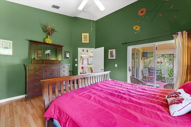 7235 Sharpsburg Blvd, New Port Richey, FL 34653 - bedroom featuring visible vents, access to exterior, wood finished floors, high vaulted ceiling, and baseboards