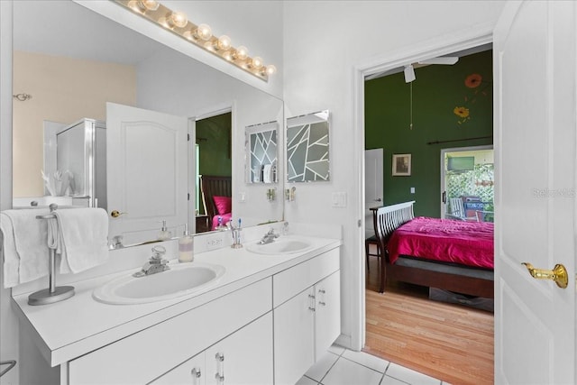 7235 Sharpsburg Blvd, New Port Richey, FL 34653 - ensuite bathroom featuring double vanity, tile patterned floors, a sink, and ensuite bath