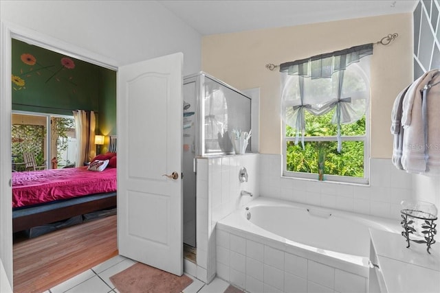 7235 Sharpsburg Blvd, New Port Richey, FL 34653 - ensuite bathroom featuring a bath, connected bathroom, a stall shower, and a wealth of natural light