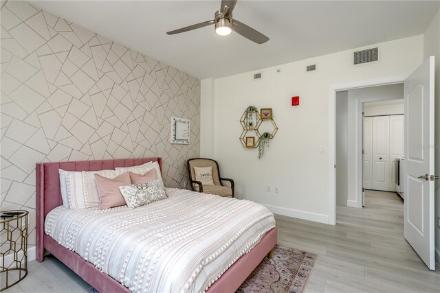 bedroom with tile walls, visible vents, and an accent wall