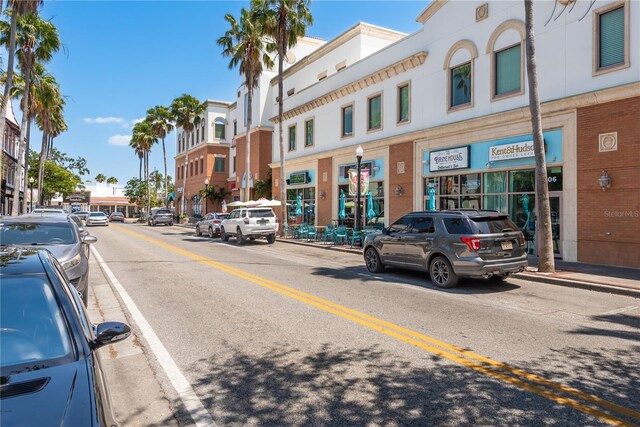 view of street with street lighting, sidewalks, and curbs