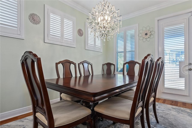 1432 Gopher Loop, Tarpon Springs, FL 34689 - dining room featuring an inviting chandelier, ornamental molding, baseboards, and wood finished floors