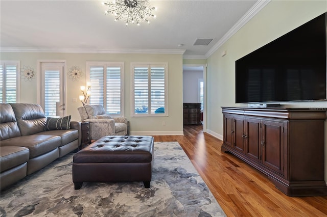 1432 Gopher Loop, Tarpon Springs, FL 34689 - living room featuring a notable chandelier, light wood-style floors, baseboards, visible vents, and ornamental molding