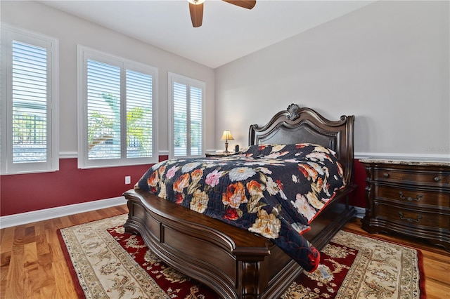 1432 Gopher Loop, Tarpon Springs, FL 34689 - bedroom with a ceiling fan, baseboards, multiple windows, and wood finished floors