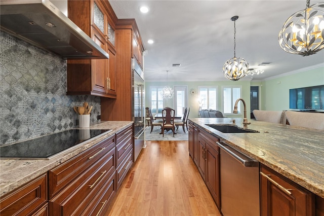 1432 Gopher Loop, Tarpon Springs, FL 34689 - kitchen featuring a chandelier, ventilation hood, a sink, appliances with stainless steel finishes, and light wood-style flooring
