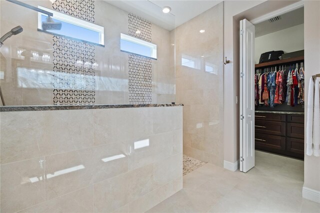 1432 Gopher Loop, Tarpon Springs, FL 34689 - bathroom featuring a walk in shower, a spacious closet, and baseboards