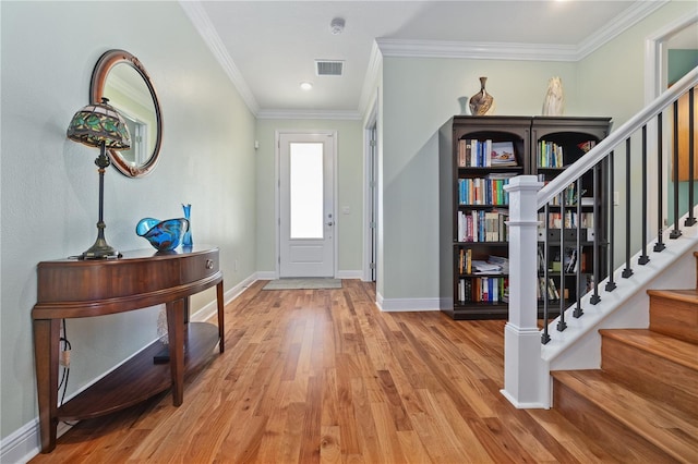 1432 Gopher Loop, Tarpon Springs, FL 34689 - foyer with light wood-style flooring, ornamental molding, baseboards, and stairs
