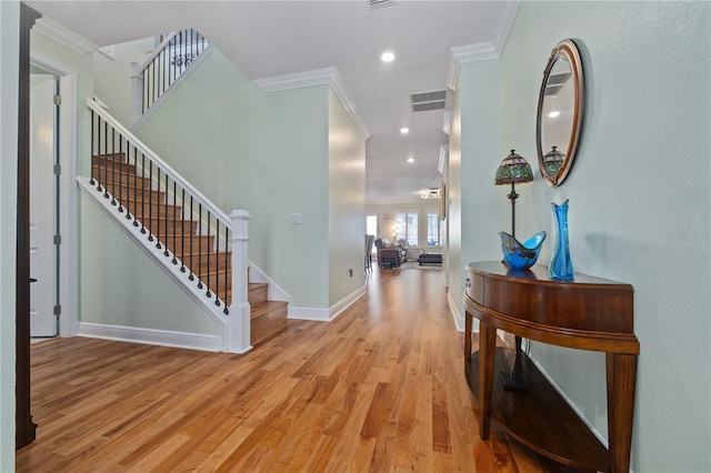 1432 Gopher Loop, Tarpon Springs, FL 34689 - foyer featuring ornamental molding, light wood-style flooring, stairway, baseboards, and recessed lighting