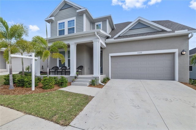 1432 Gopher Loop, Tarpon Springs, FL 34689 - view of front of property with a porch, roof with shingles, driveway, an attached garage, and stucco siding