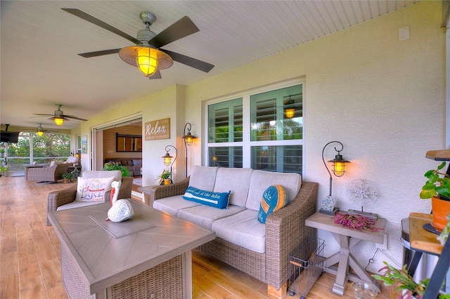 exterior space featuring an outdoor living space and ceiling fan