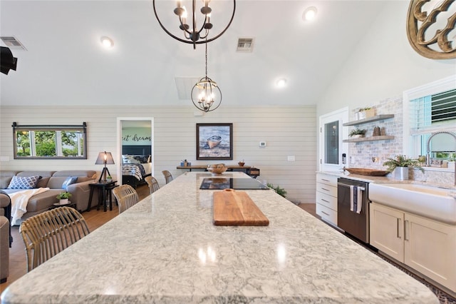kitchen with stainless steel dishwasher, an inviting chandelier, and visible vents