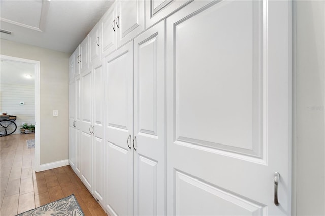 hallway with baseboards and wood finished floors