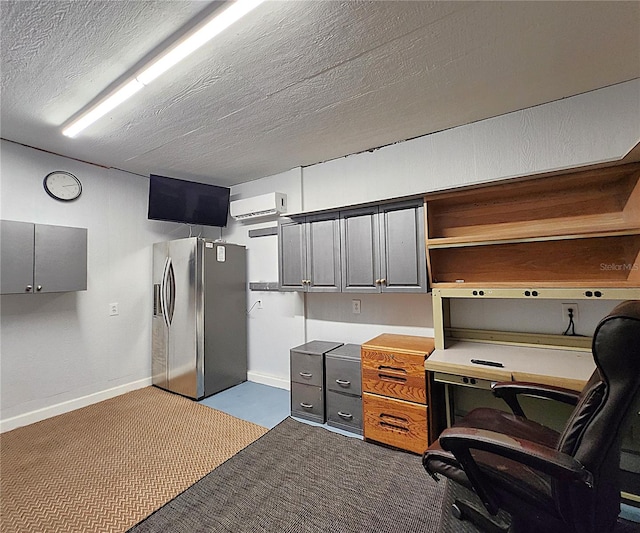 home office with an AC wall unit, baseboards, a textured ceiling, and dark colored carpet