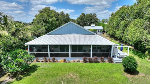 1395 S Lake Reedy Blvd, Frostproof, FL 33843 - rear view of house featuring a sunroom and a yard