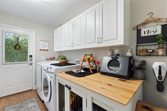 1395 S Lake Reedy Blvd, Frostproof, FL 33843 - laundry area with washing machine and dryer, light wood-style flooring, and cabinet space