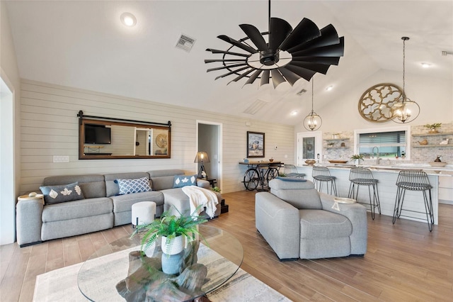 1395 S Lake Reedy Blvd, Frostproof, FL 33843 - living area featuring light wood-style floors, high vaulted ceiling, and a chandelier
