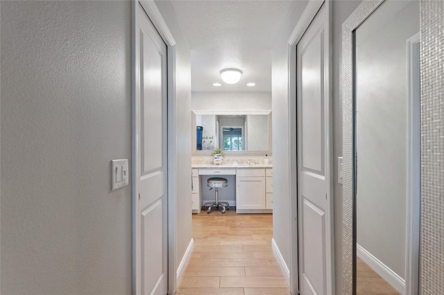 1395 S Lake Reedy Blvd, Frostproof, FL 33843 - hall featuring light wood-style flooring, a desk, and baseboards