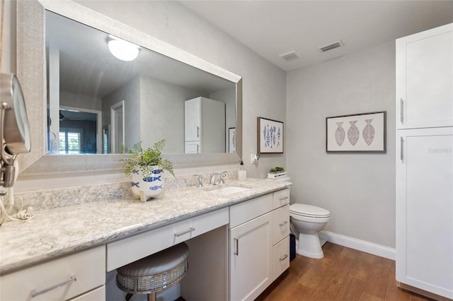 1395 S Lake Reedy Blvd, Frostproof, FL 33843 - bathroom with toilet, wood finished floors, vanity, and baseboards
