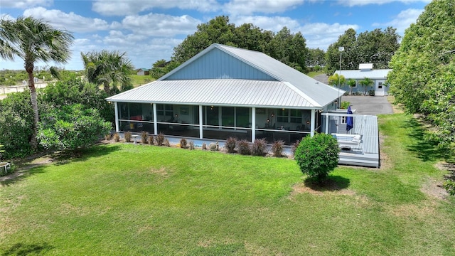 1395 S Lake Reedy Blvd, Frostproof, FL 33843 - back of house with a sunroom, a lawn, and metal roof