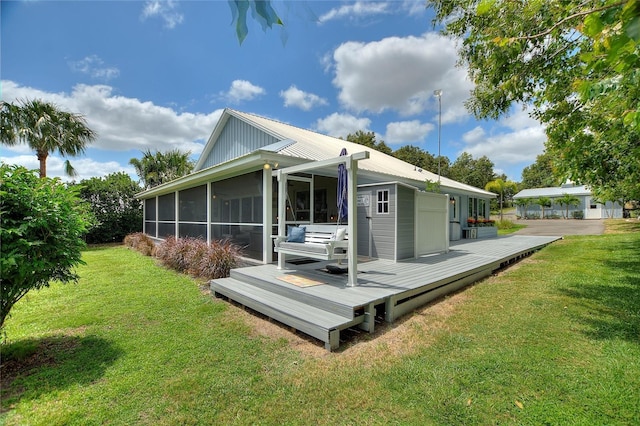 1395 S Lake Reedy Blvd, Frostproof, FL 33843 - back of house with a deck, a yard, a sunroom, and metal roof