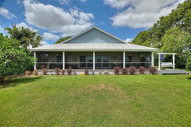 1395 S Lake Reedy Blvd, Frostproof, FL 33843 - rear view of house with ceiling fan, a lawn, a sunroom, and metal roof