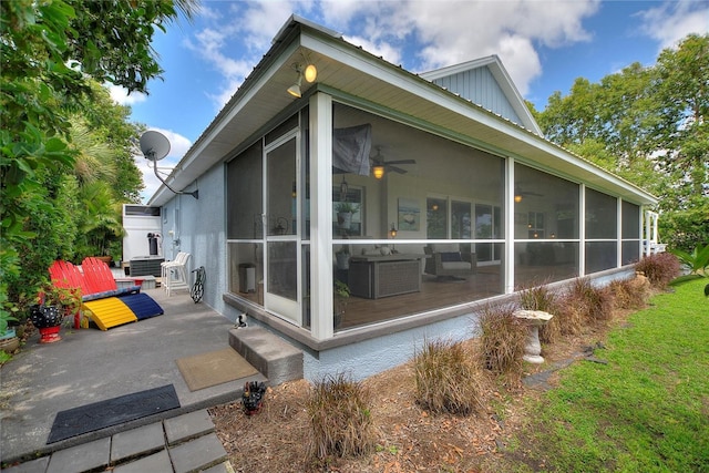 1395 S Lake Reedy Blvd, Frostproof, FL 33843 - view of side of home with a sunroom, board and batten siding, a patio, and central air condition unit