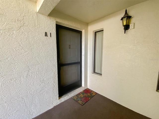 2643 Pine Ridge Way S Unit A1, Palm Harbor, FL 34684 - property entrance with stucco siding
